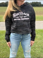 Person wearing a black hoodie with 'Shiloh Leather Company' text, standing outdoors.